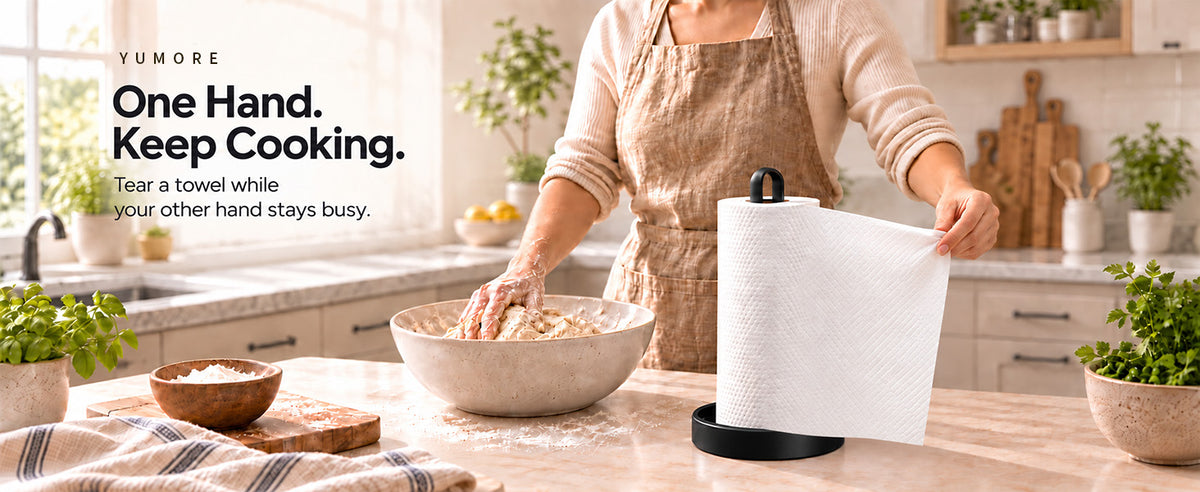 Original Amazon A+ black countertop paper-towel holder in kitchen while person kneads dough and tears towel, original text overlay